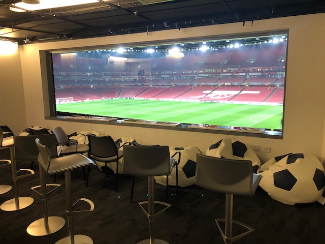 This photo is of the Arsenal Sensory Room viewing area which allows those supporters to watch a match behind privacy glass and without the noise. Supporter can sit at the front with stools for their parents and siblings at the back.